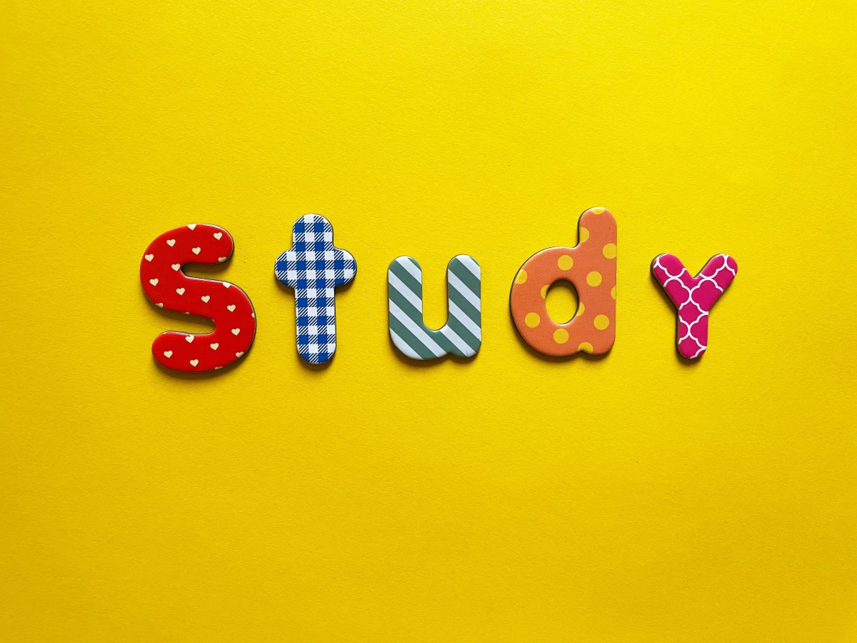 Colourful letters spelling Study on a yellow background